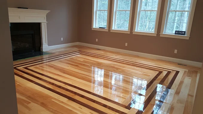 Reflective finished hardwood floor with a detailed border