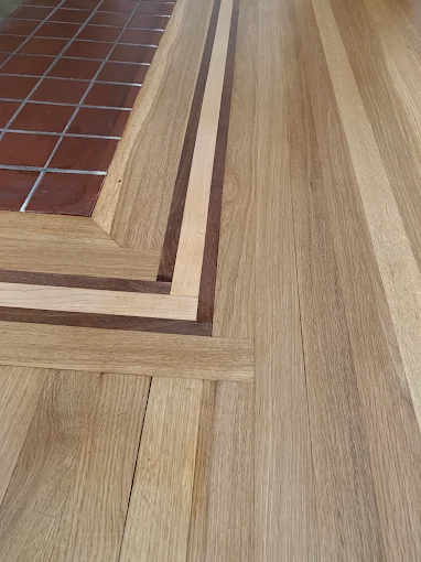 Detailed hardwood floor border crafted around a hearth