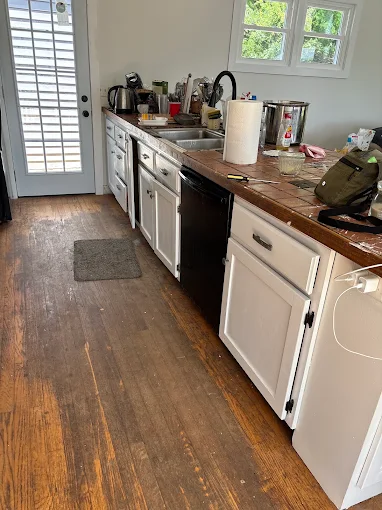 Worn kitchen hardwood floor before sanding and refinishing