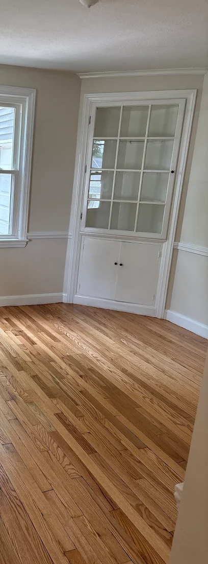 Finished hardwood floor beside the built-in dining room cabinet