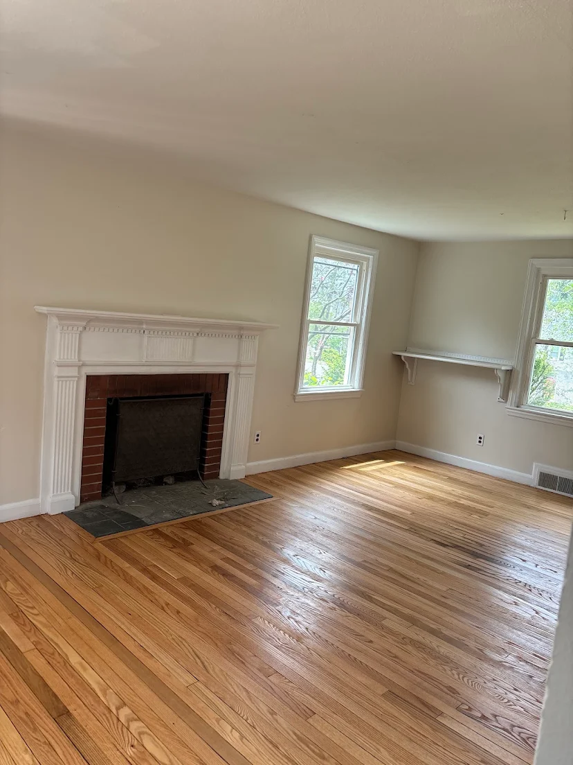 Finished hardwood floor in the fireplace room