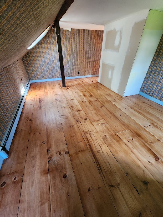 Wide white pine attic floor after refinishing
