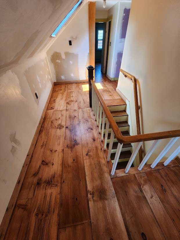 Wide white pine upstairs landing after sanding and refinishing